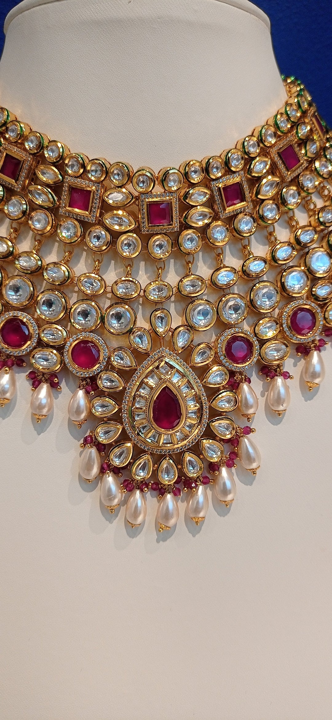 Simina Imitation Ruby and Polki Diamond Kundan Necklace, Earrings and Teeka Bridal Jewellery Set